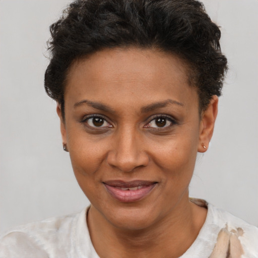 Joyful latino adult female with short  brown hair and brown eyes