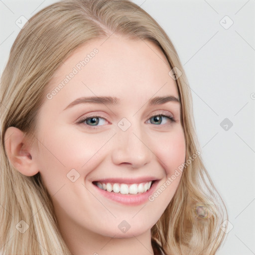 Joyful white young-adult female with long  brown hair and blue eyes