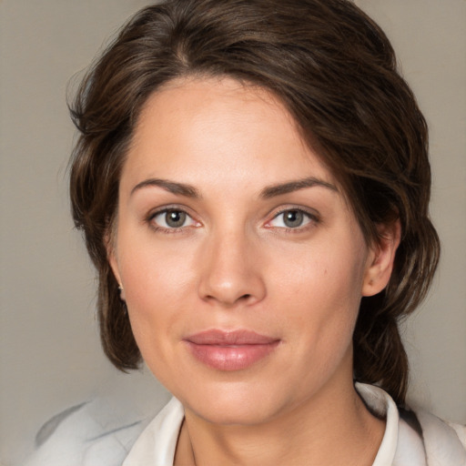 Joyful white young-adult female with medium  brown hair and green eyes