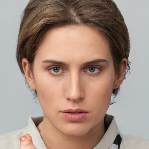 Neutral white young-adult female with short  brown hair and grey eyes