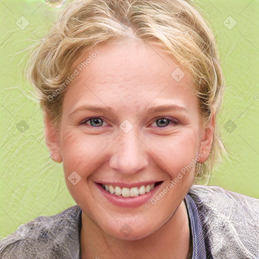 Joyful white young-adult female with short  brown hair and blue eyes