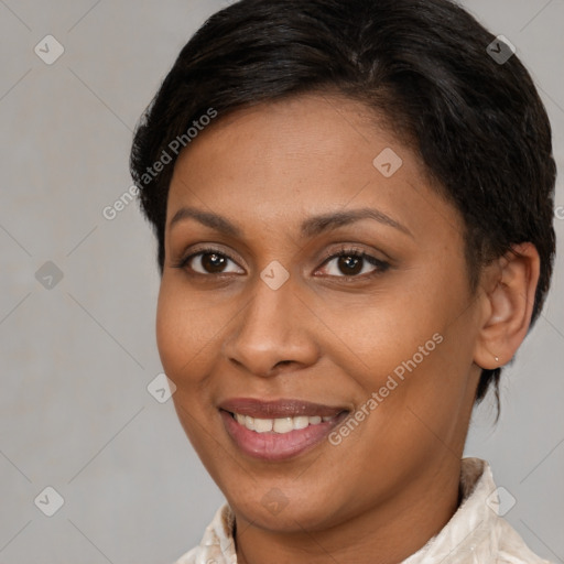 Joyful latino young-adult female with short  brown hair and brown eyes