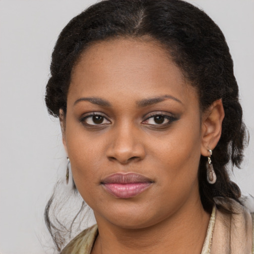 Joyful black young-adult female with long  brown hair and brown eyes