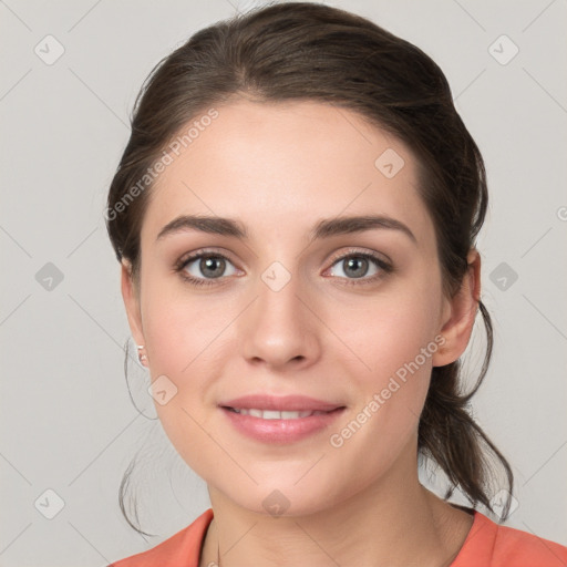 Joyful white young-adult female with medium  brown hair and grey eyes