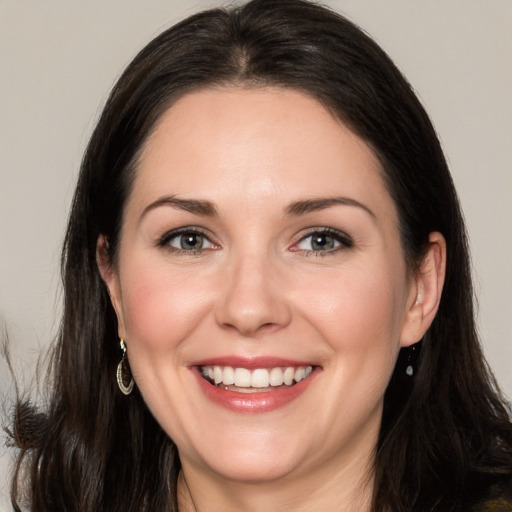 Joyful white adult female with long  brown hair and brown eyes