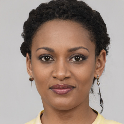 Joyful black young-adult female with short  brown hair and brown eyes