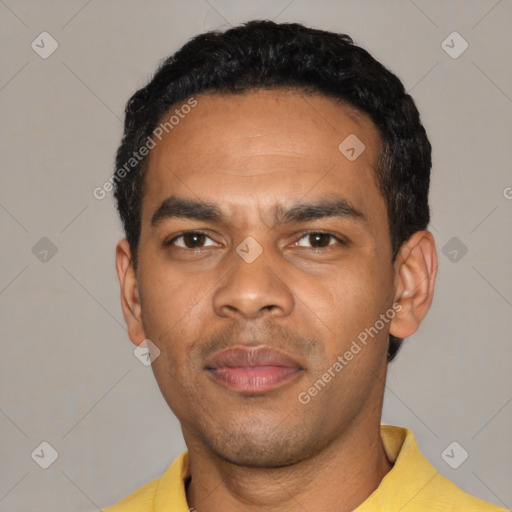 Joyful black young-adult male with short  black hair and brown eyes
