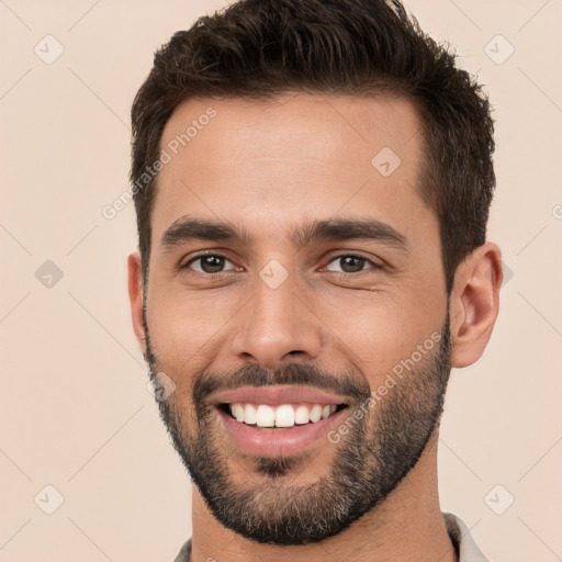 Joyful white young-adult male with short  brown hair and brown eyes