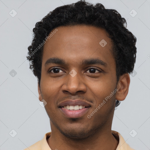 Joyful black young-adult male with short  black hair and brown eyes