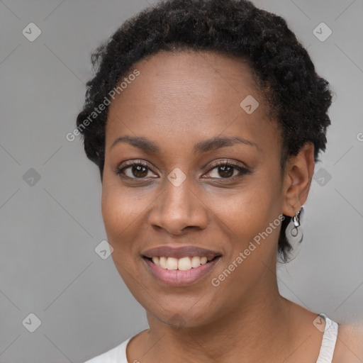 Joyful black young-adult female with short  black hair and brown eyes