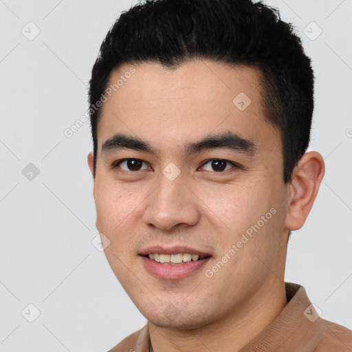 Joyful latino young-adult male with short  black hair and brown eyes