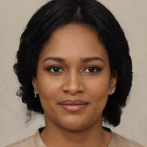 Joyful black young-adult female with medium  black hair and brown eyes