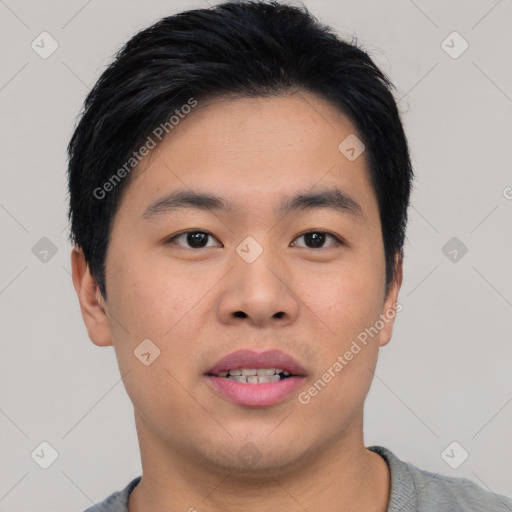 Joyful asian young-adult male with short  black hair and brown eyes