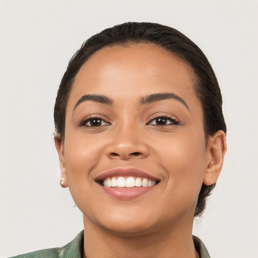 Joyful latino young-adult female with short  black hair and brown eyes