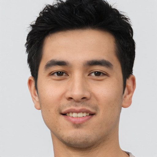 Joyful asian young-adult male with short  black hair and brown eyes