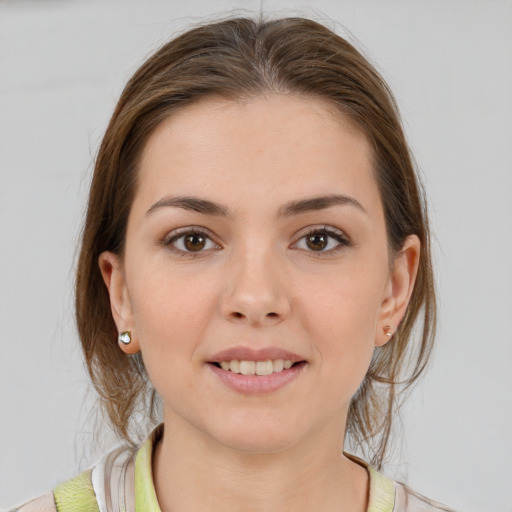 Joyful white young-adult female with medium  brown hair and grey eyes