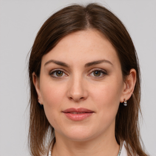 Joyful white young-adult female with medium  brown hair and grey eyes