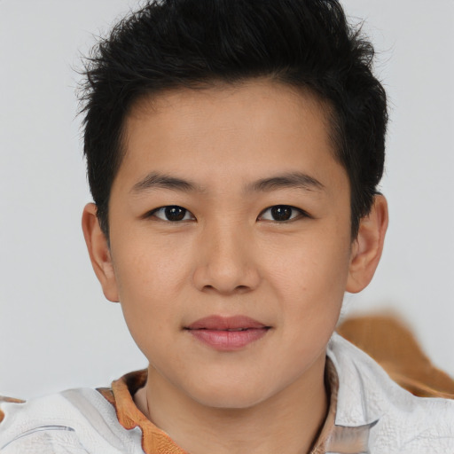Joyful asian child male with short  brown hair and brown eyes