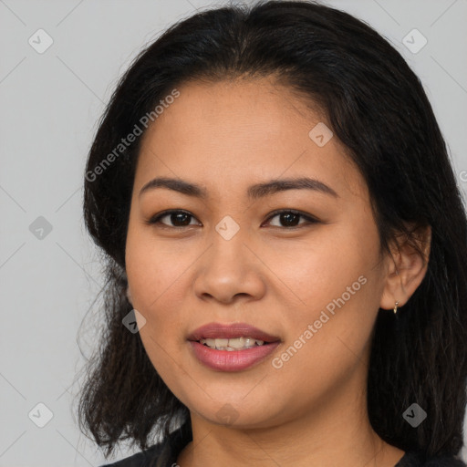 Joyful latino young-adult female with long  brown hair and brown eyes