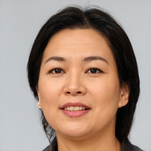 Joyful asian adult female with medium  brown hair and brown eyes