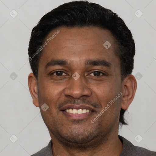 Joyful latino young-adult male with short  black hair and brown eyes