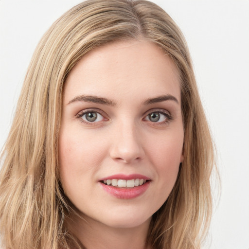 Joyful white young-adult female with long  brown hair and green eyes