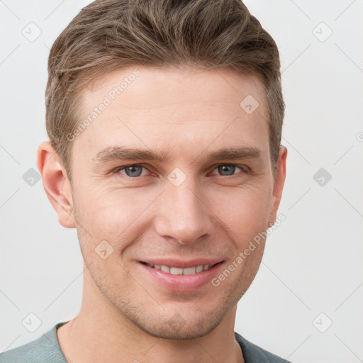 Joyful white young-adult male with short  brown hair and grey eyes