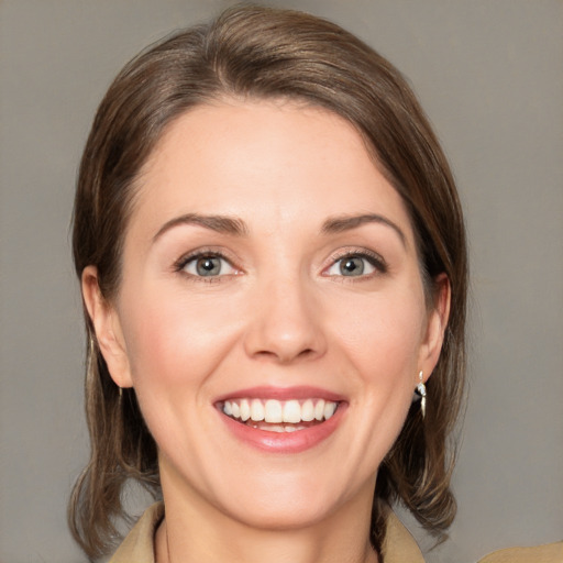 Joyful white young-adult female with medium  brown hair and green eyes