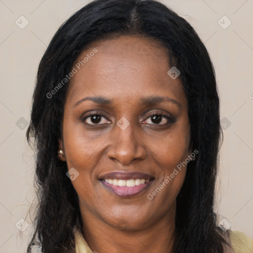 Joyful black adult female with long  brown hair and brown eyes