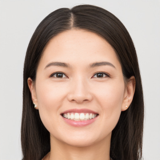 Joyful white young-adult female with long  black hair and brown eyes