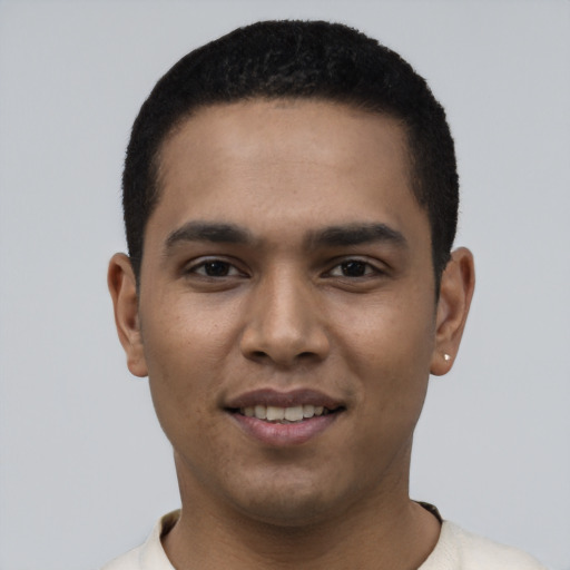 Joyful latino young-adult male with short  black hair and brown eyes