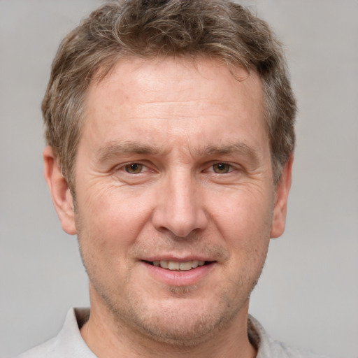 Joyful white adult male with short  brown hair and grey eyes