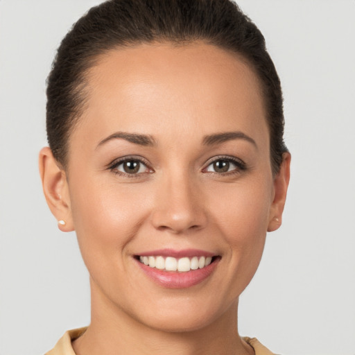 Joyful white young-adult female with short  brown hair and brown eyes