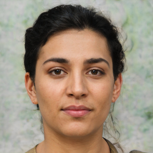 Joyful latino young-adult female with short  brown hair and brown eyes