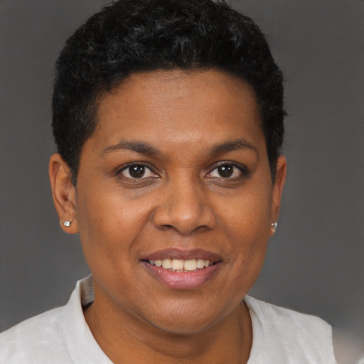 Joyful black adult female with short  brown hair and brown eyes