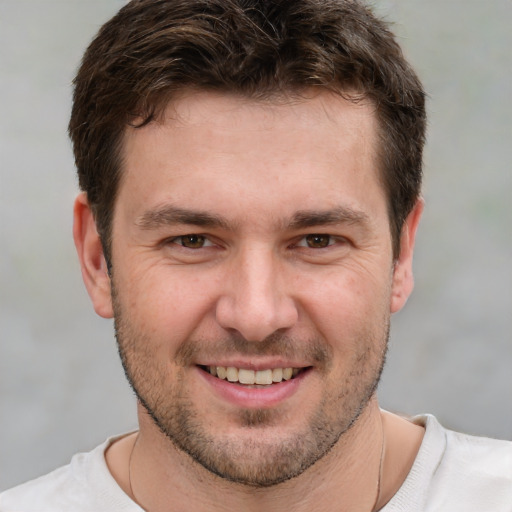 Joyful white young-adult male with short  brown hair and brown eyes