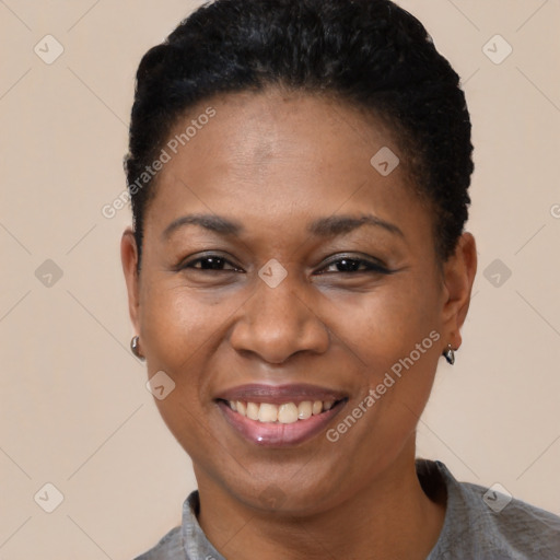 Joyful black young-adult female with short  brown hair and brown eyes