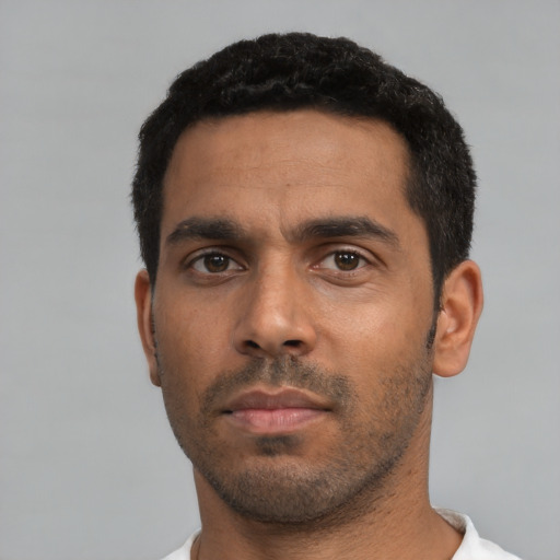Neutral latino young-adult male with short  black hair and brown eyes