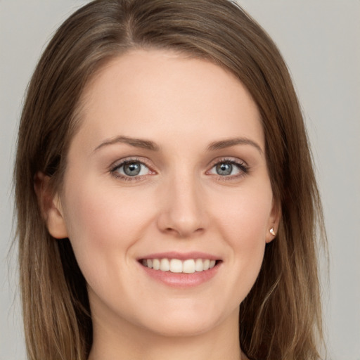 Joyful white young-adult female with long  brown hair and grey eyes