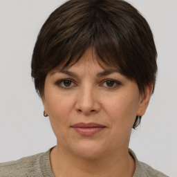 Joyful white adult female with short  brown hair and brown eyes