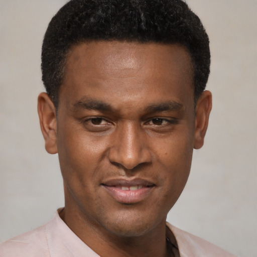 Joyful black young-adult male with short  brown hair and brown eyes