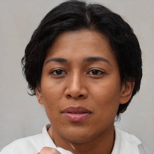 Joyful asian adult female with short  brown hair and brown eyes