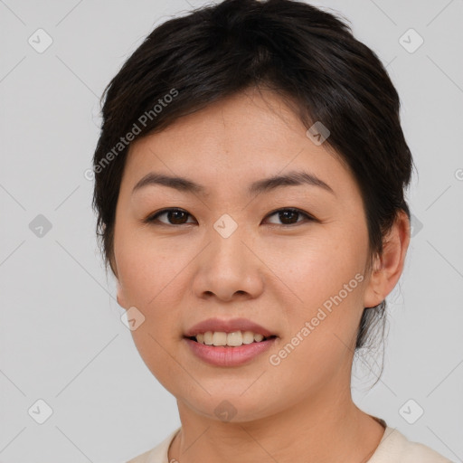 Joyful asian young-adult female with short  brown hair and brown eyes