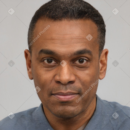 Joyful black adult male with short  black hair and brown eyes