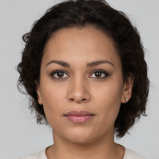 Joyful latino young-adult female with long  brown hair and brown eyes