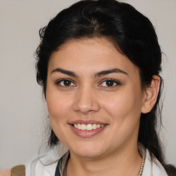 Joyful latino young-adult female with medium  brown hair and brown eyes