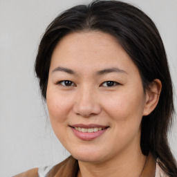 Joyful white adult female with medium  brown hair and brown eyes