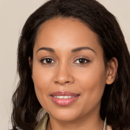 Joyful latino young-adult female with long  brown hair and brown eyes