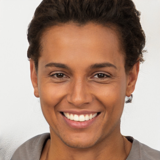 Joyful white young-adult female with short  brown hair and brown eyes