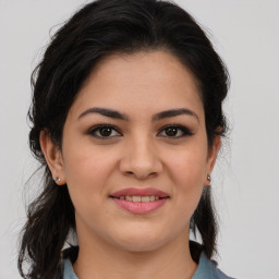 Joyful latino young-adult female with medium  brown hair and brown eyes